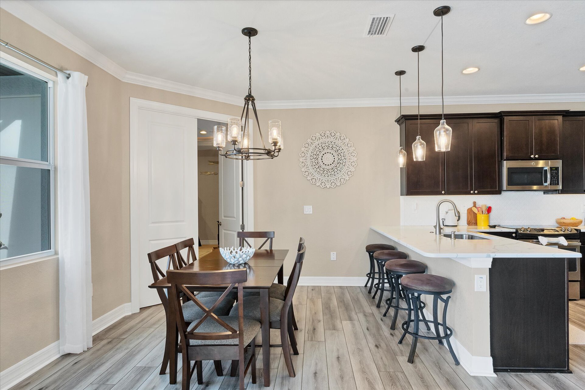 Dining area overlooking pool and canal. Dining table seats 6. Kitchen bar seats another 4