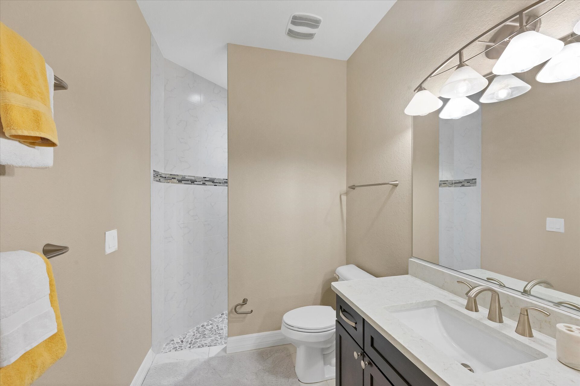 Guest bathroom features a large walk-in shower