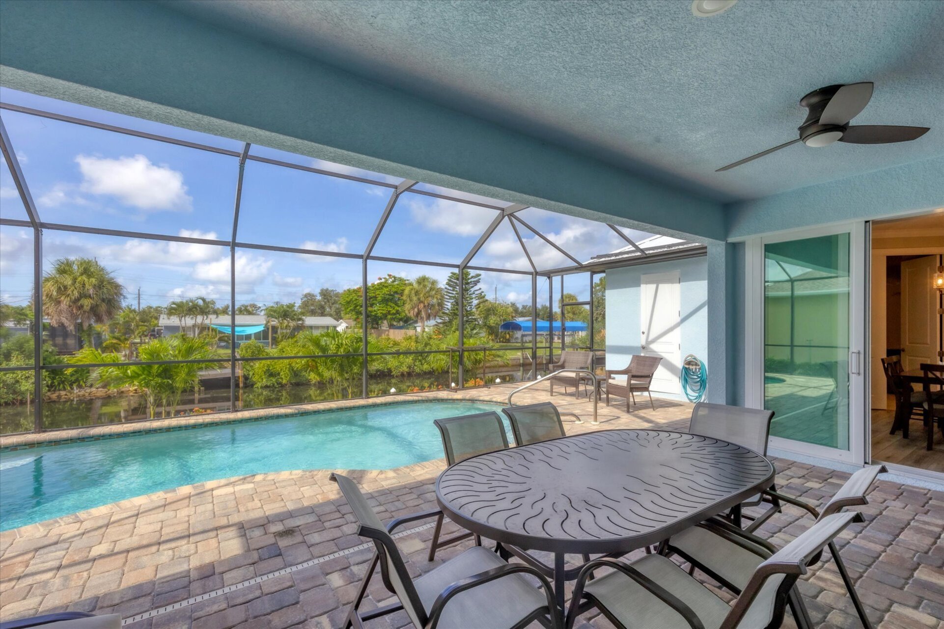 Gorgeous, large lanai with sparkling pool overlooking the canal. Lanai also features a dining table for 6 and 32-inch Smart TV. Pool size: 22' x 8' x 6'D