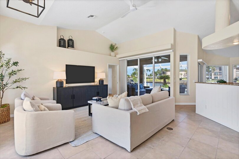 Bright, open living space with ample seating and 65-inch Smart TV