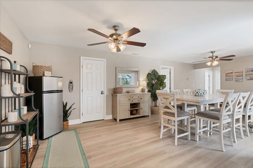 Dining room with additional refrigerator and lanai aceess. Dining table seats 8
