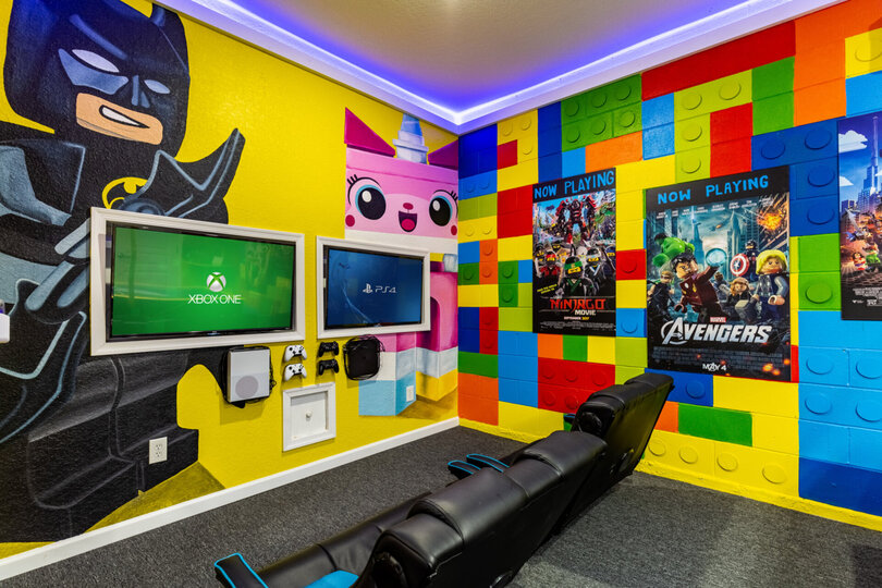The gaming setup features two 43-inch TVs connected to an Xbox One and Playstation 4