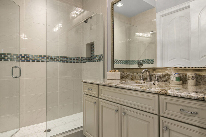 The en-suite bathroom has a walk-in shower built to match the suite