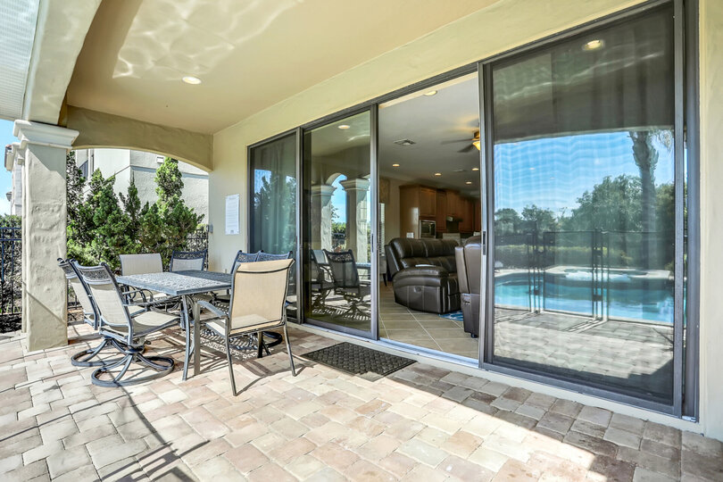 Dine al fresco under the covered lanai at the outdoor table with seating for 6