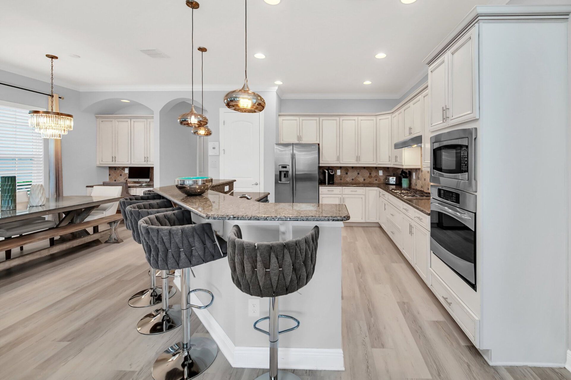 Fully equipped kitchen with stainless steel appliances and breakfast bar with seating for 6