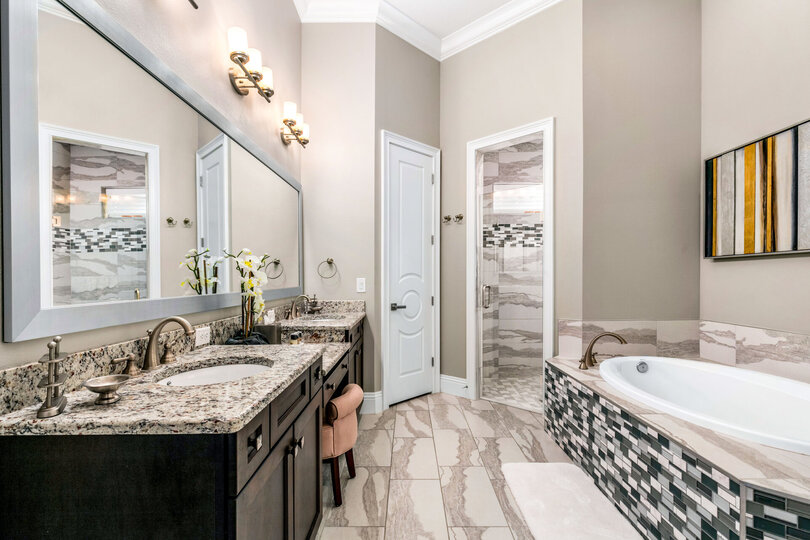 En-suite bathroom with dual vanity, walk-in shower, and garden tub for relaxation
