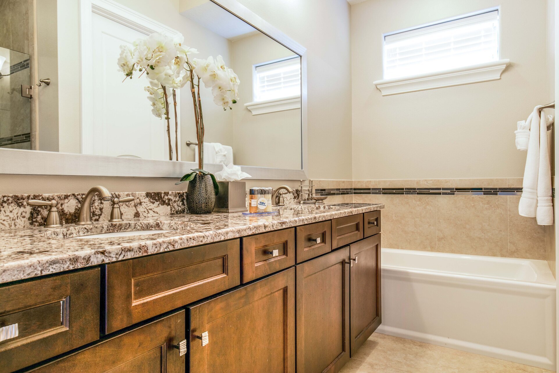 En-suite bathrrom with dual vanity, walk-in shower, and tub