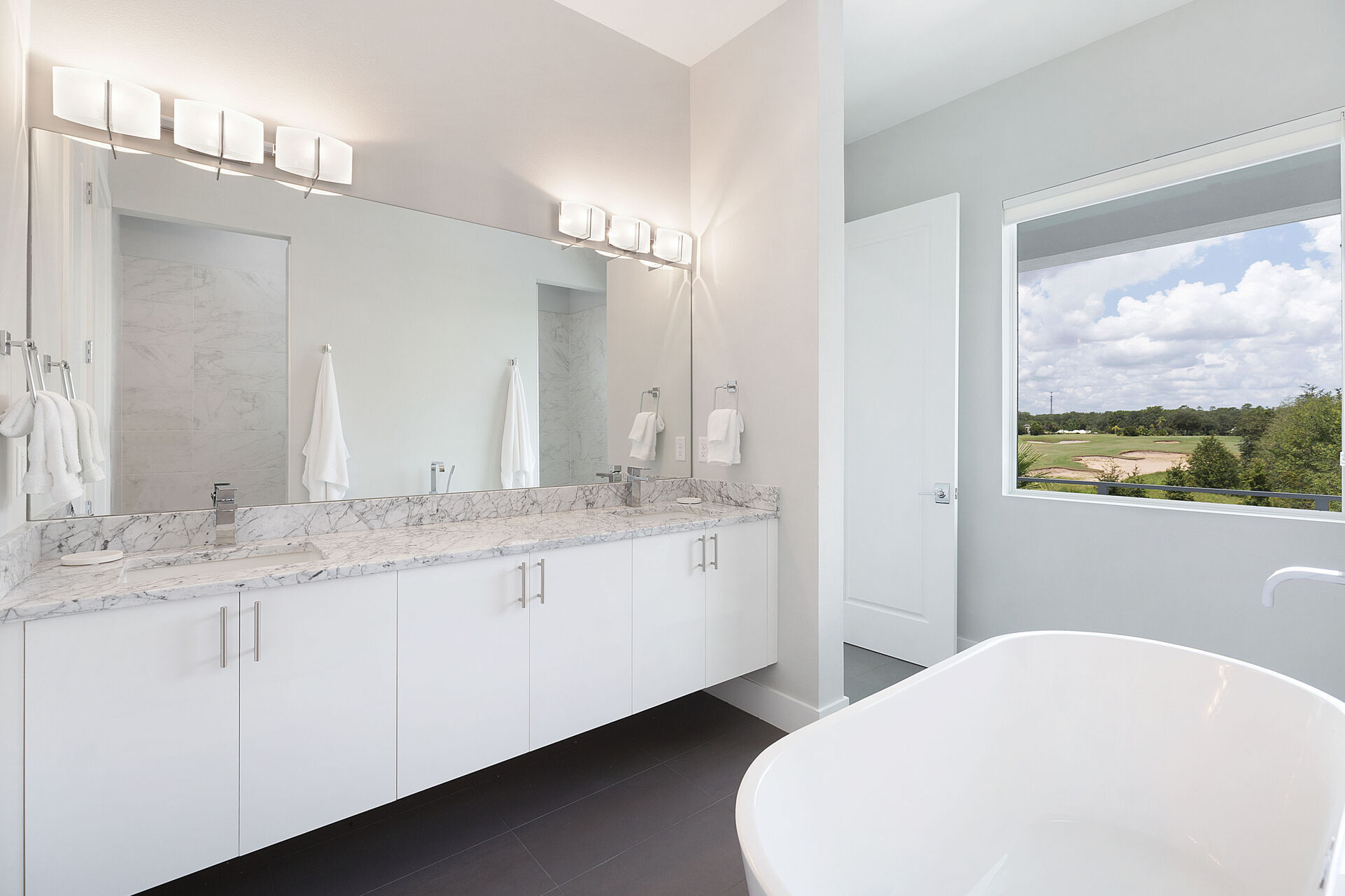 The ensuite bathroom with a garden tub and dual vanity