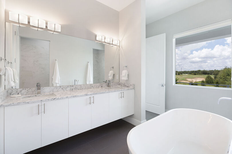 The ensuite bathroom with a garden tub and dual vanity