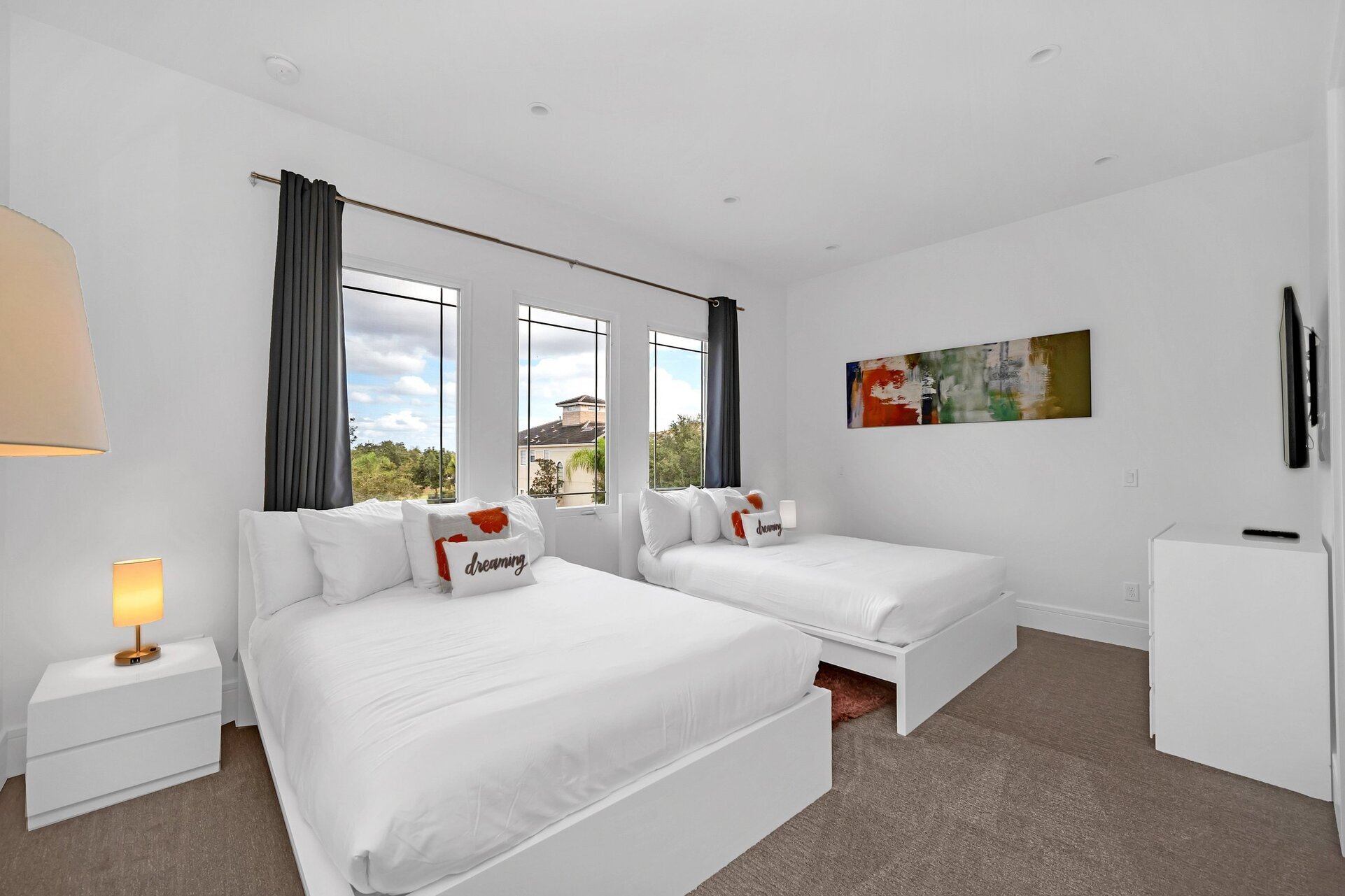 This spacious bedroom features 2 queen-sized beds