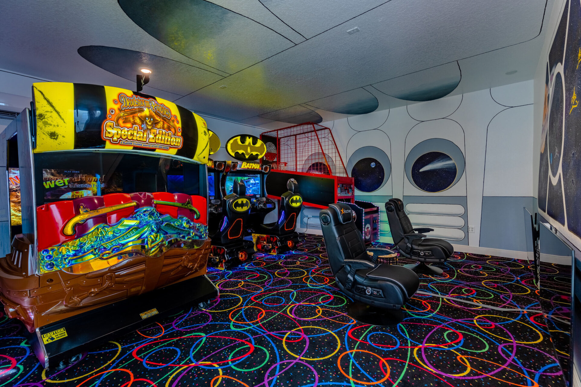 The garage arcade room features professional arcade games, including Batman riders, Pirates riders, and a basketball game, in addition to Xbox and PS5 gaming systems.