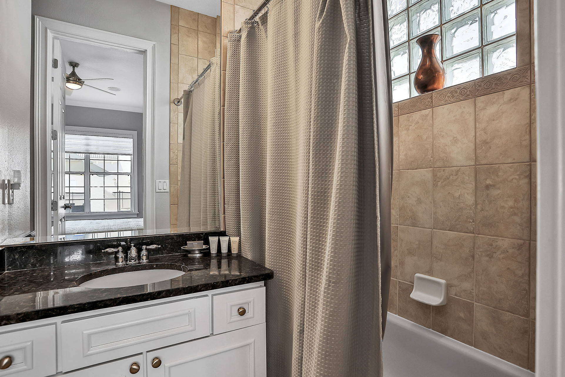 This en suite bathroom has a combined tub and shower