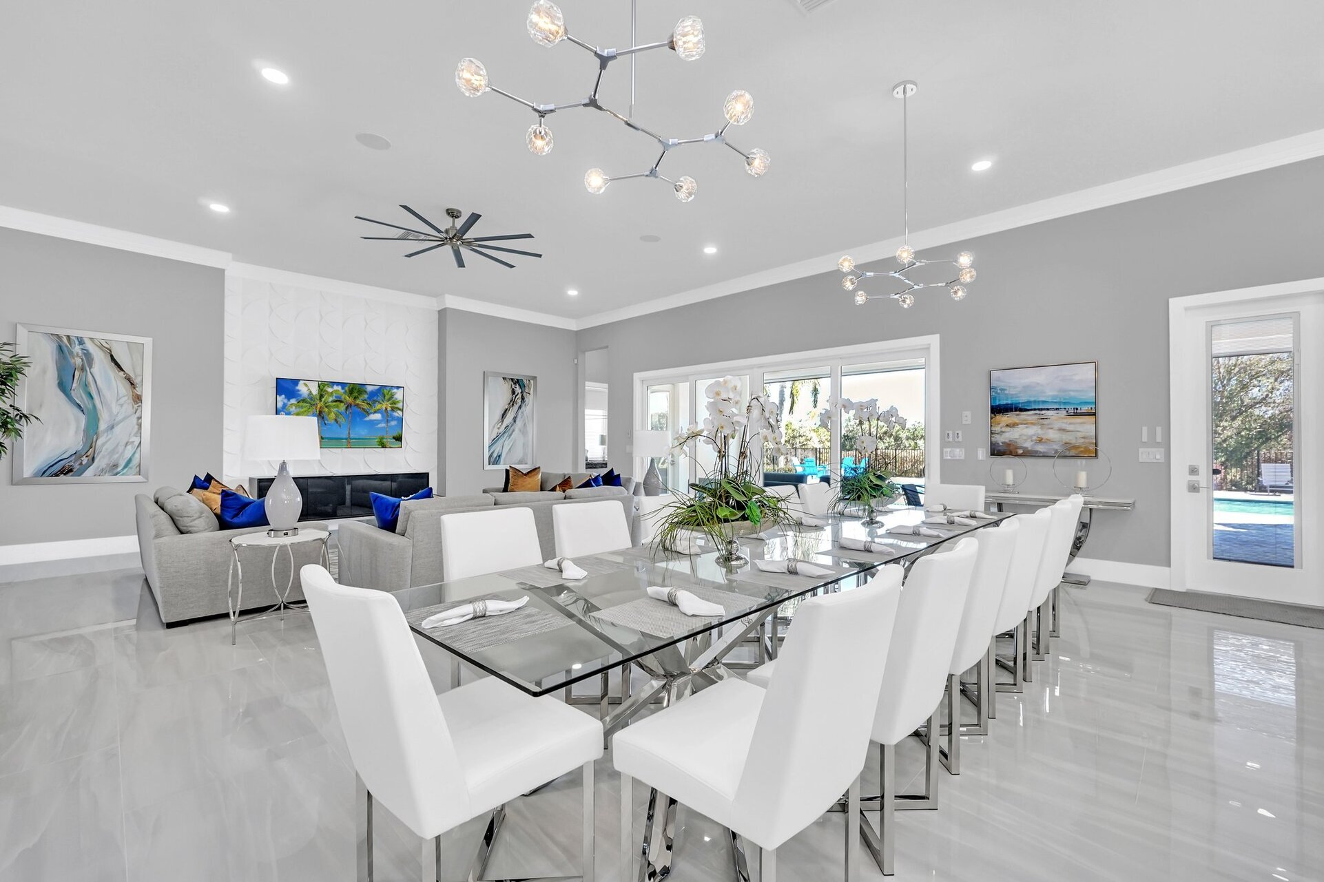 Our well-lit, open-plan dining area features chic white chairs and ample seating for your large group. Enjoy exquisite meals and create unforgettable moments!