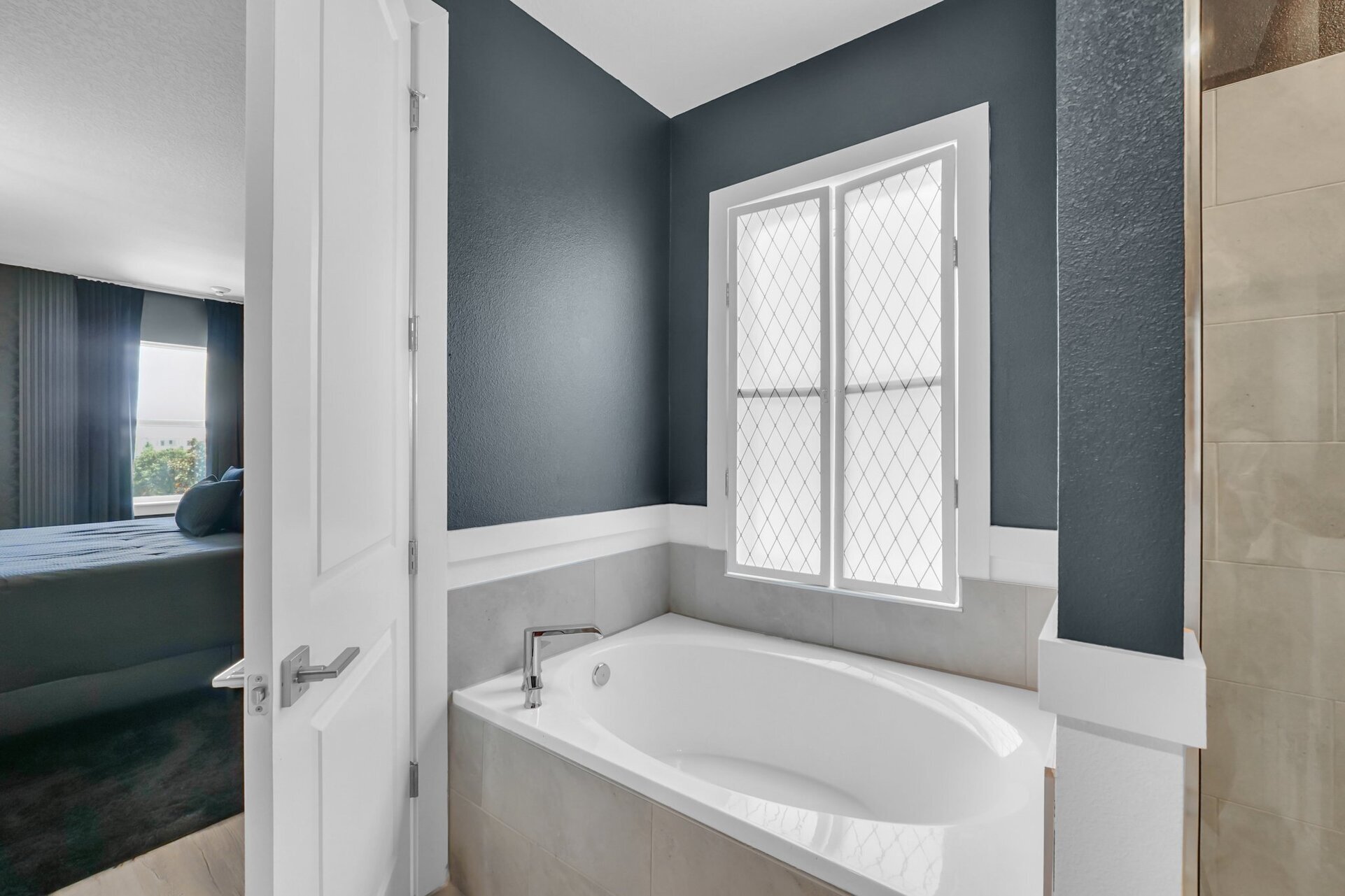 Relax in the inviting bathtub, providing a peaceful escape for a soothing soak after a long day