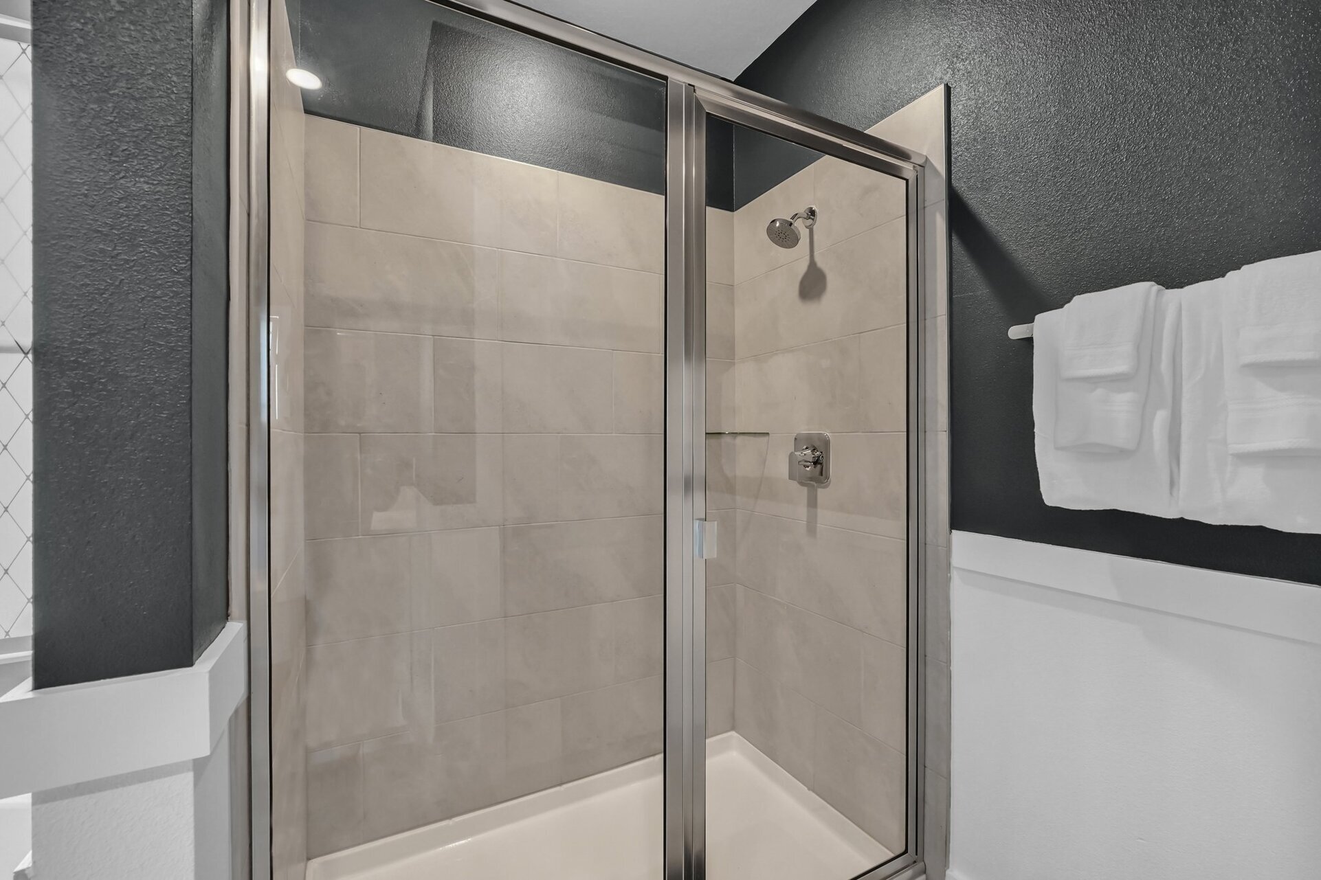Refresh yourself in the modern shower area, featuring sleek fixtures and ample space for a rejuvenating experience