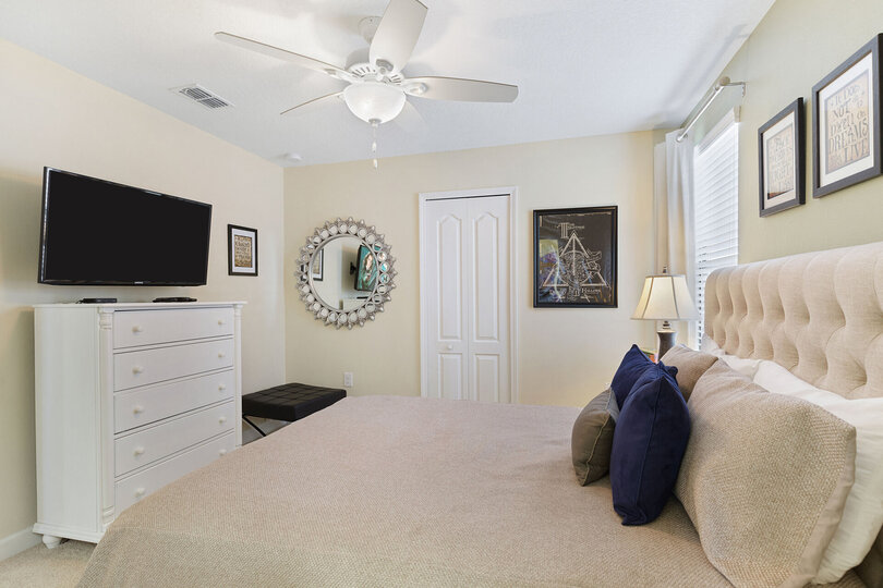 This bedroom includes a SMART TV and ceiling fan for ultimate comfort