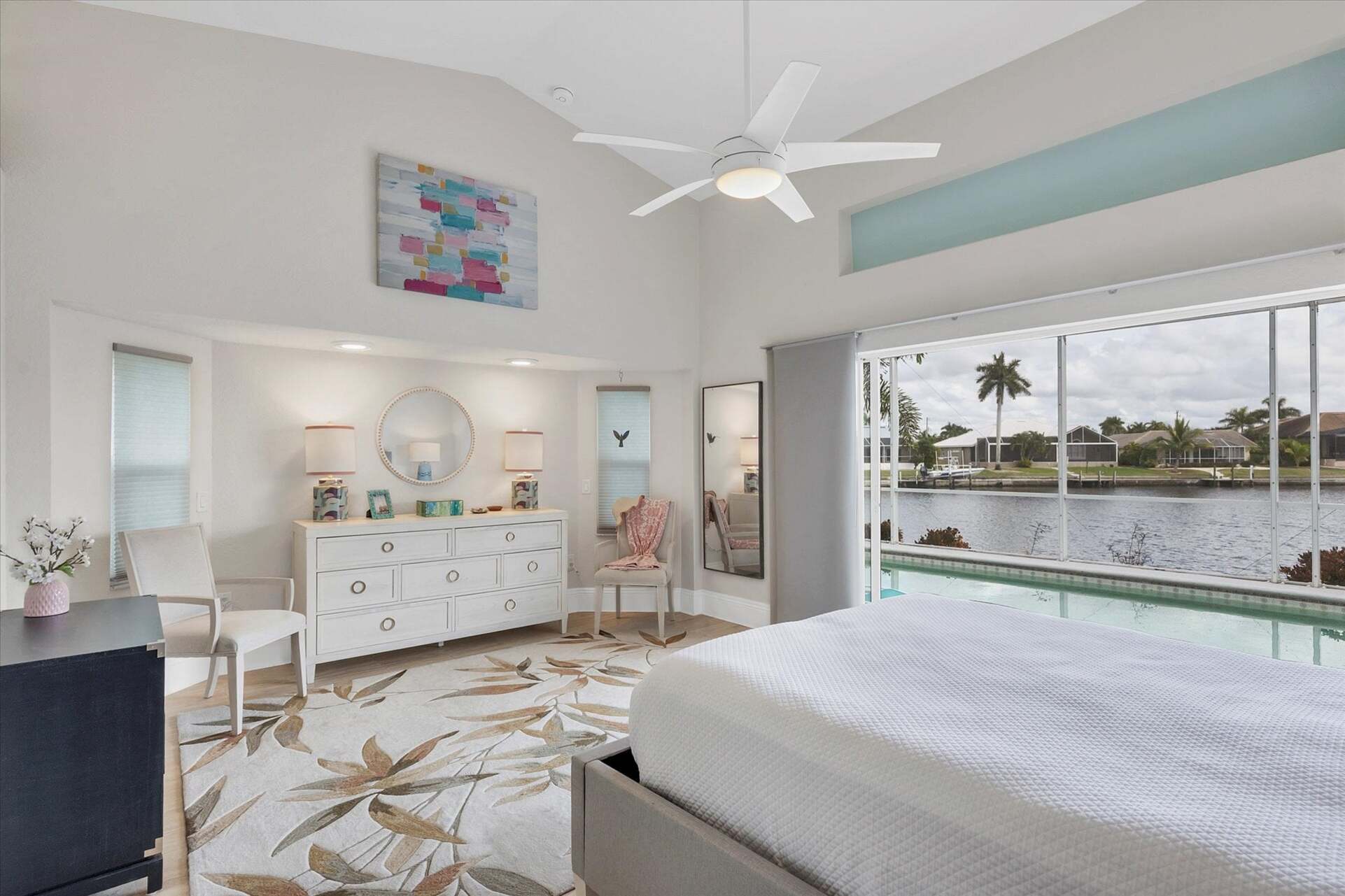 Primary bedroom with gorgeous water view, queen bed, attached bathroom and lanai access
