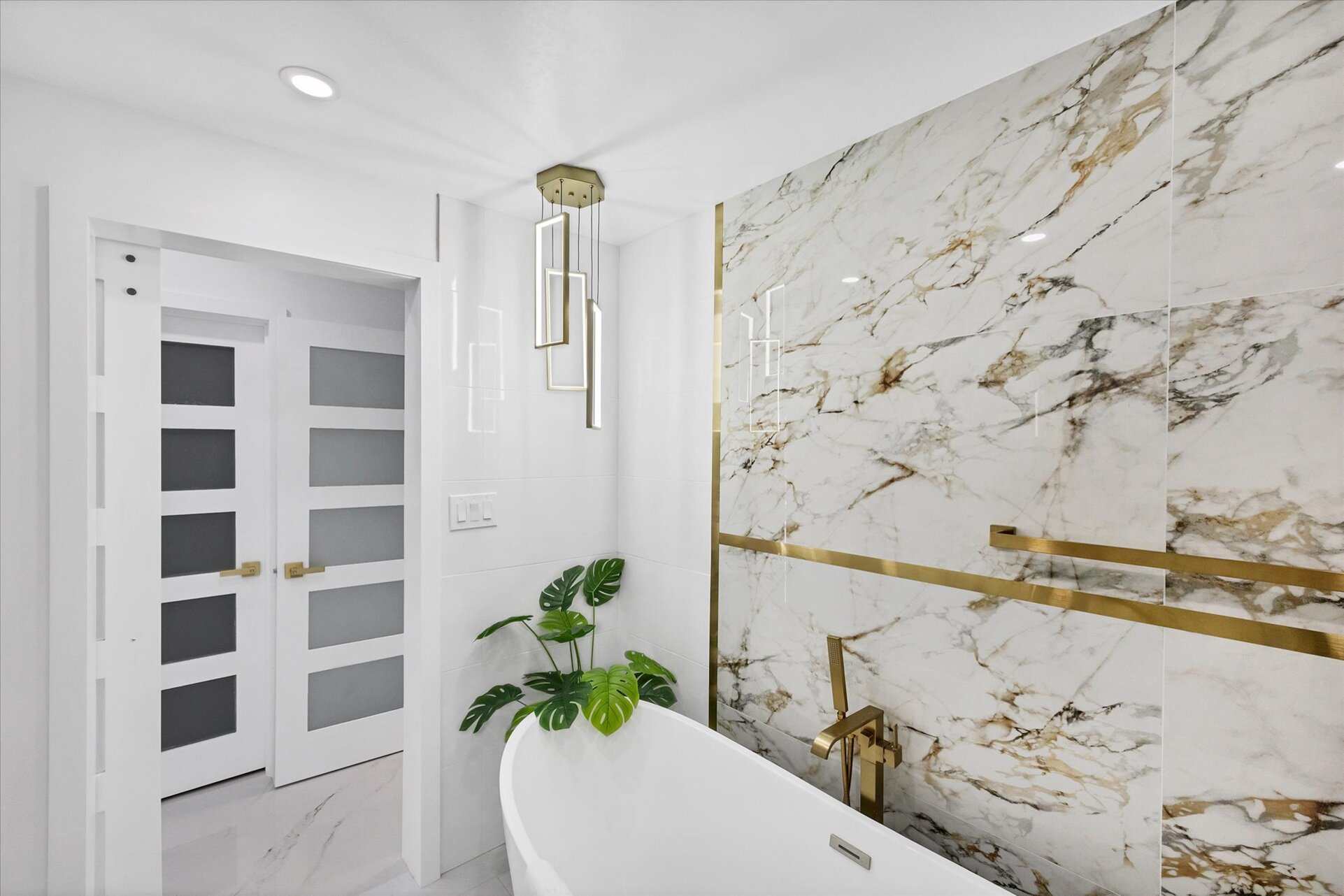 Double suite attached bathroom with walk-in shower, soaking tub, and double vanities