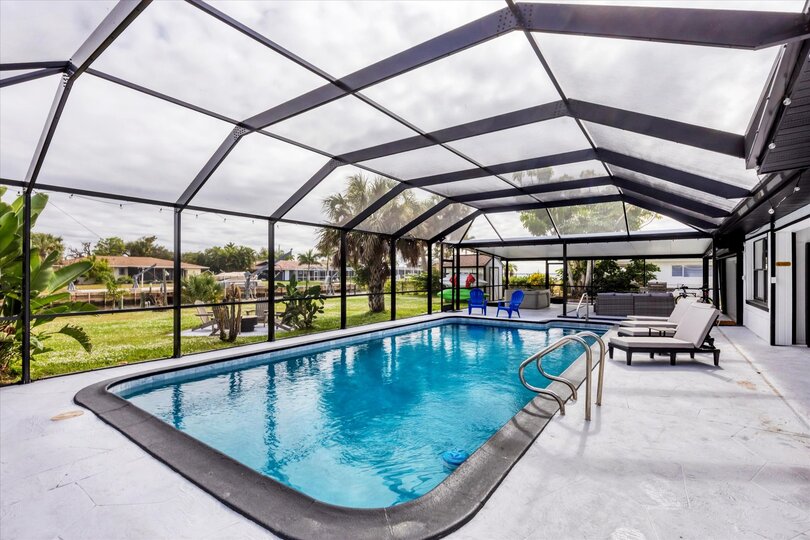 Extra large lanai overlooking the canal. Includes sparkling pool, relaxing hot tub, al fresco dining and more. Pool size: 14' x 28' x 6'
