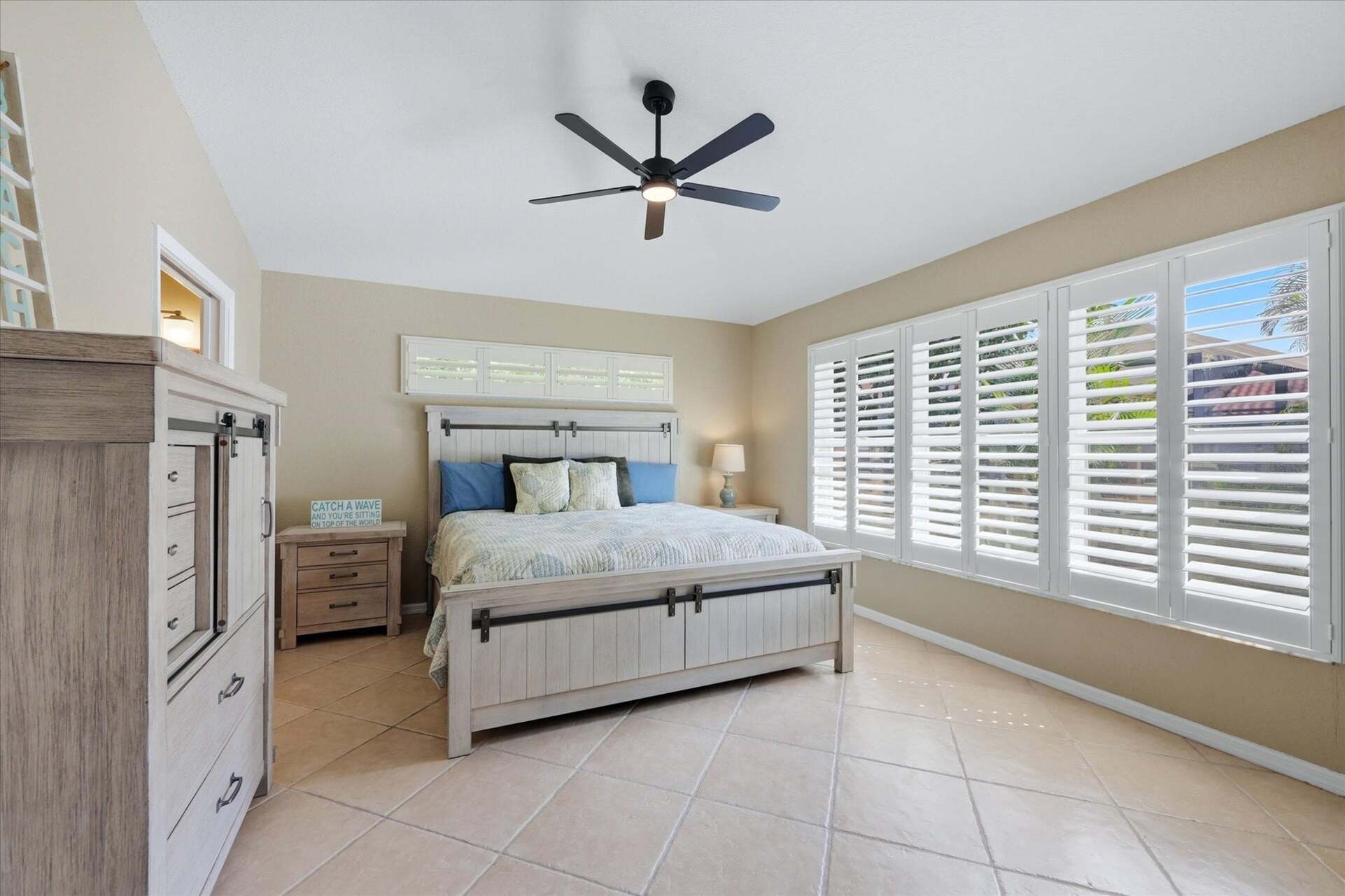 Primary bedroom with king bed, attached bathroom, and 46-inch smart TV