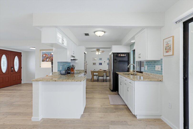 Bright, fully-equipped kitchen overlooking the pool and canal