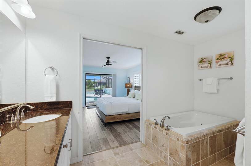 Primary bedroom attached bathroom with walk-in shower, soaking tub, and double vanities