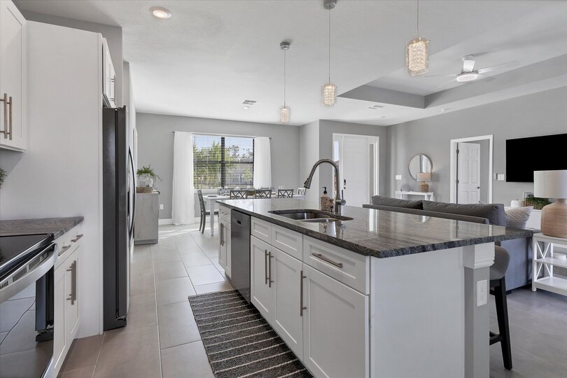 Fully equipped kitchen overlooking living room and dining area
