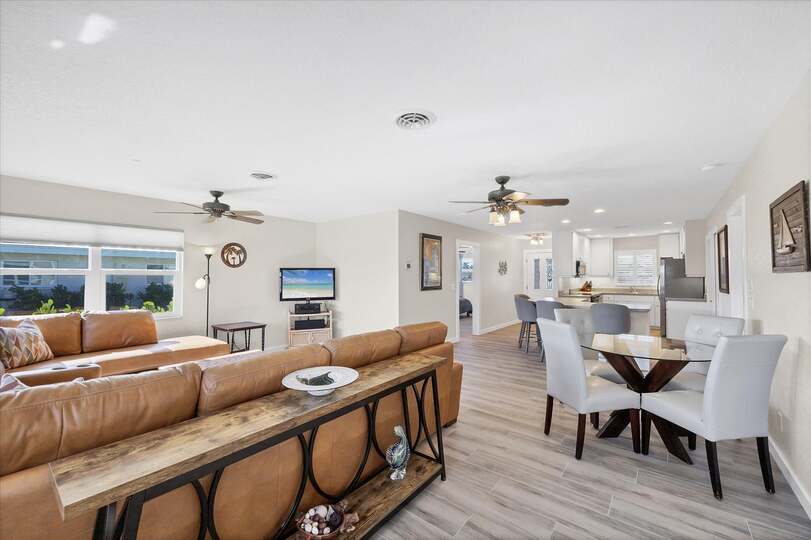 Bright, open living space. Livingroom features large sectional sofa and 50-inch Smart TV