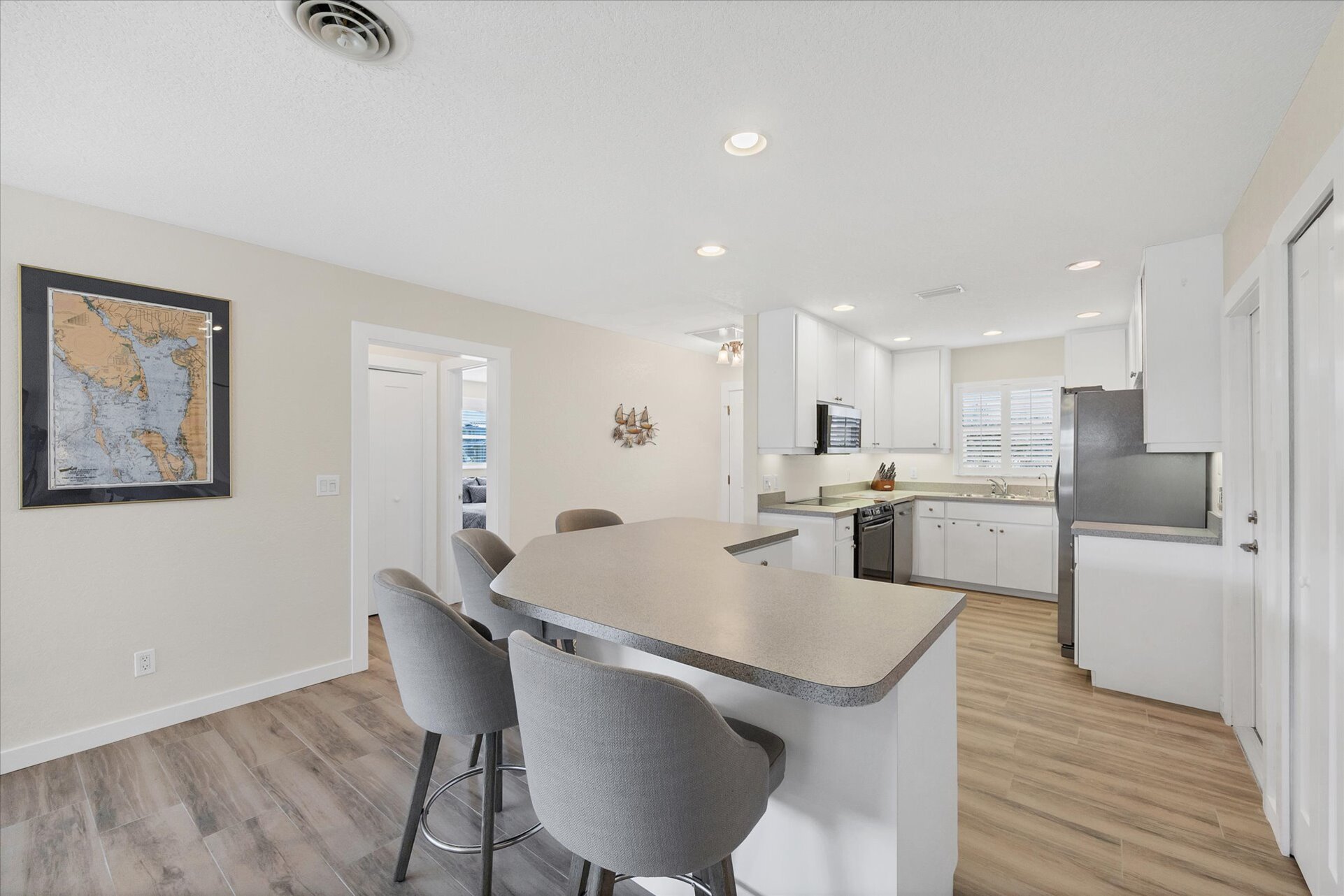 Fully-equipped kitchen overlooking the dining room and living room. Dining table seats 4 with an additional 4 at the kitchen island