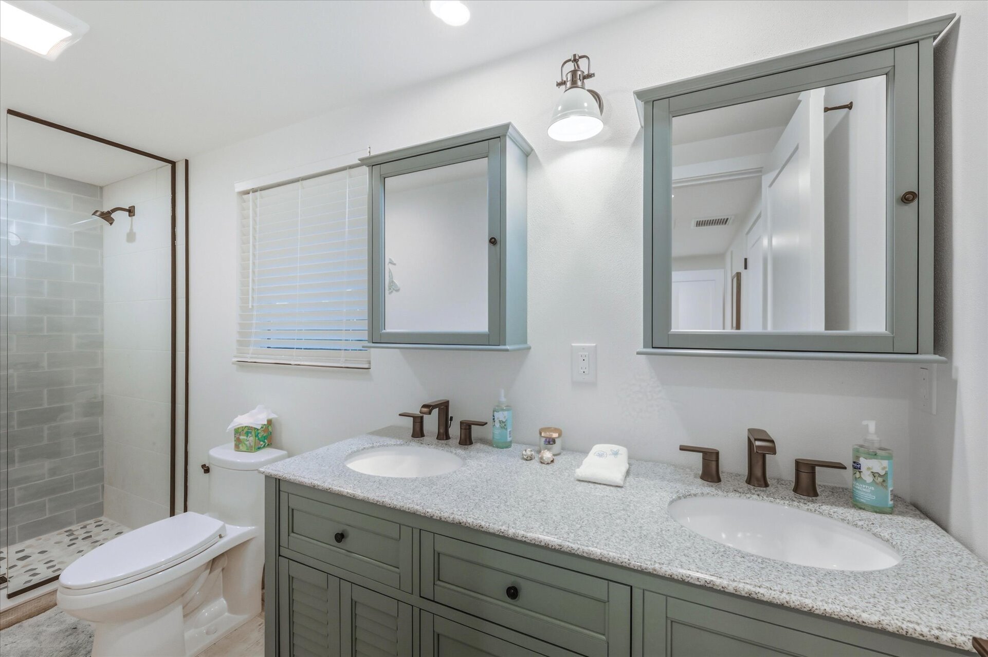 Bedroom 1's attached bathroom with walk-in shower and double vanities