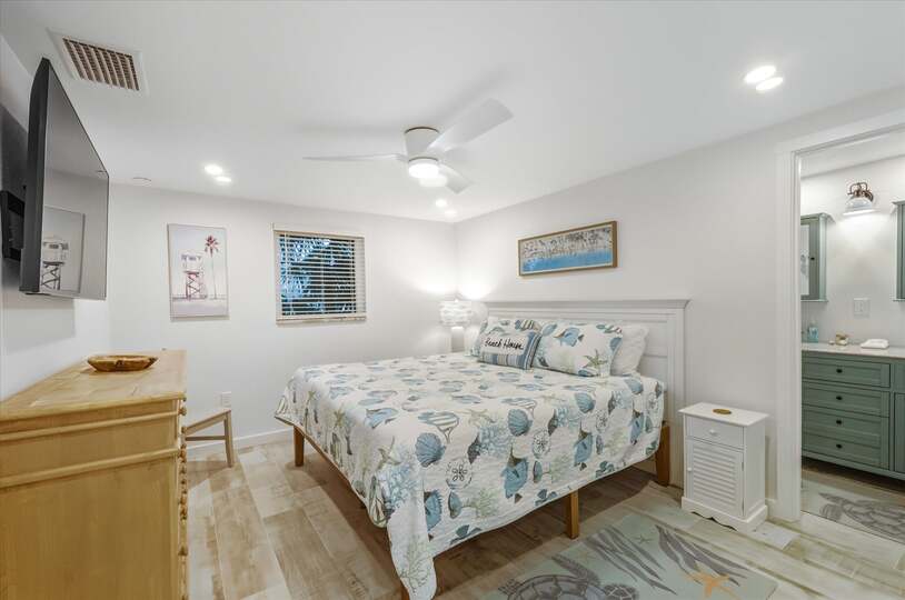 Bedroom 1 with king bed, attached bathroom and 55-inch Smart TV