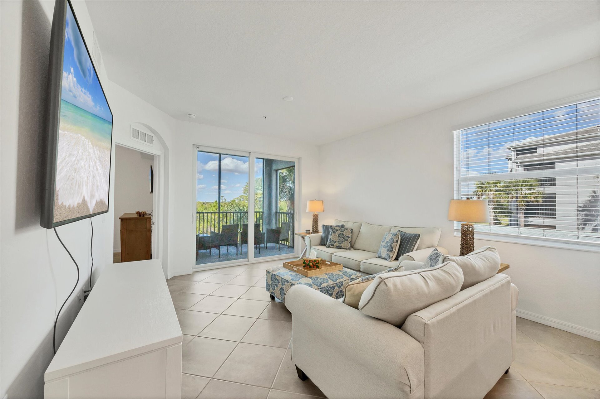 Bright, open living space. Living room overlooks the nature preserve and features ample seating and 65-inch Smart TV