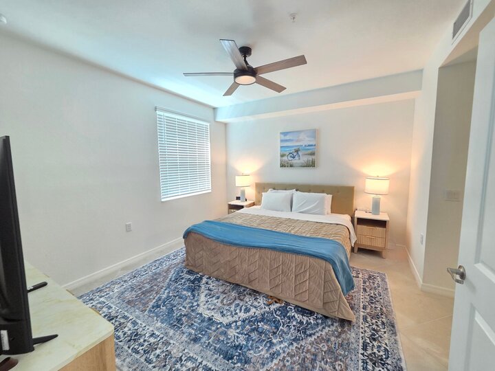 Primary bedroom with king bed, 50-inch Smart TV and attached bathroom