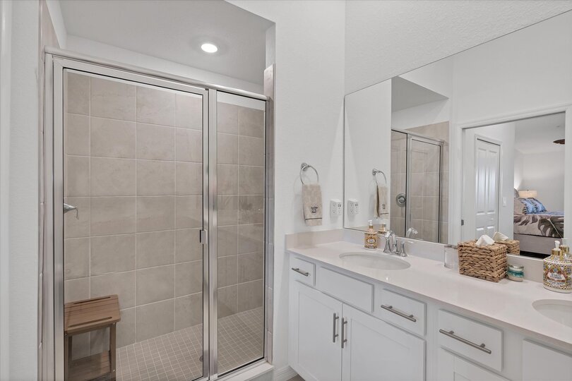 En suite with walk-in shower and double vanities