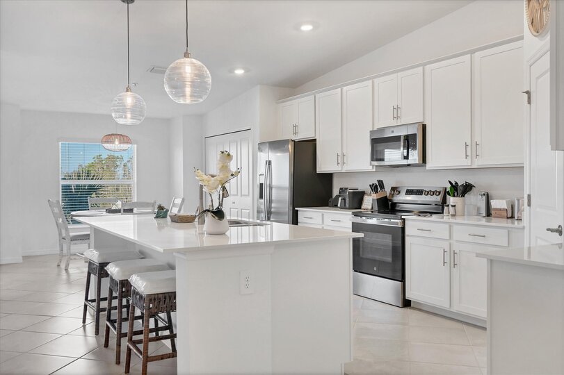 Fully-equipped kitchen over looking living room and dining area