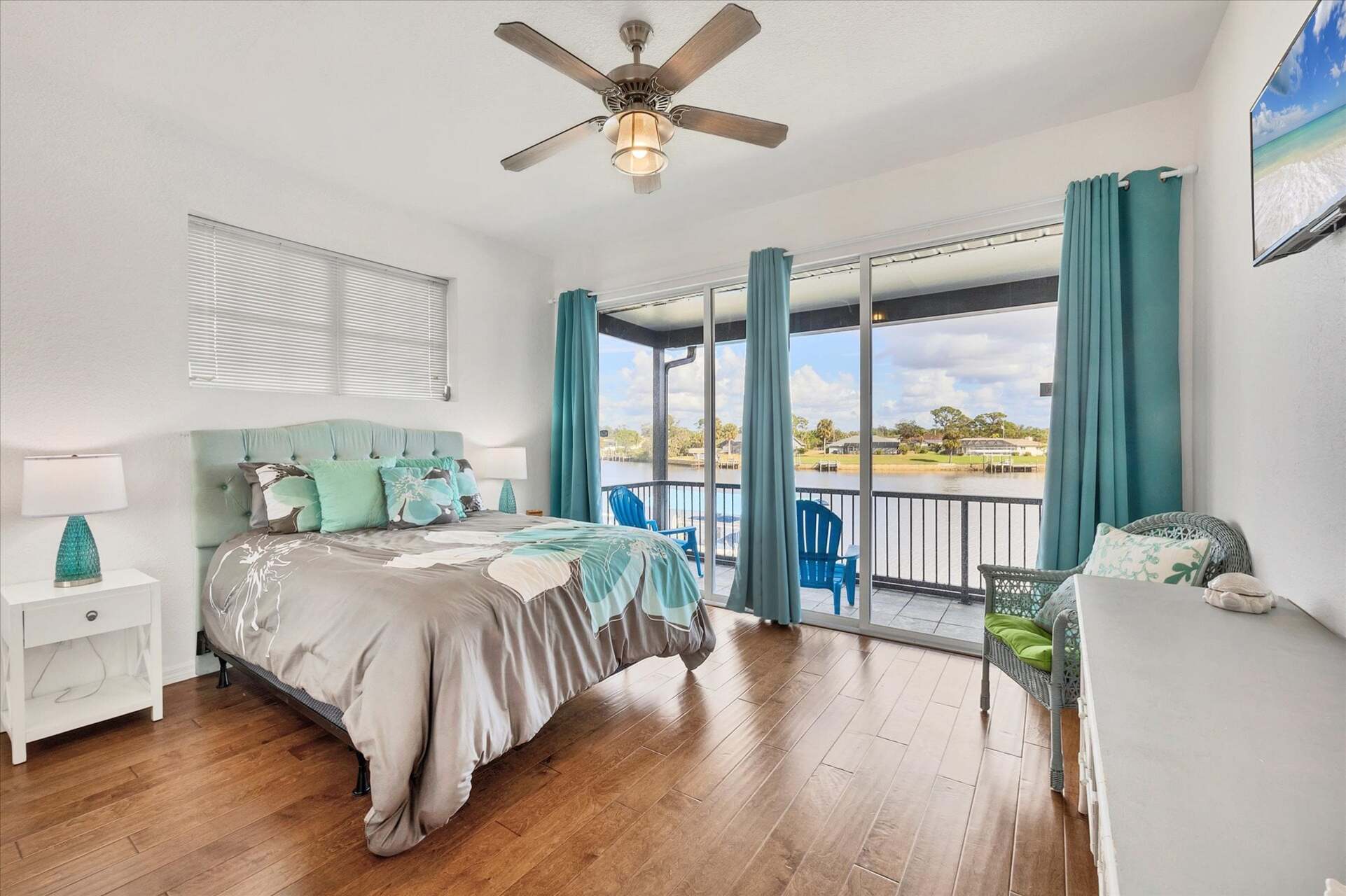 Upstairs guest bedroom 1 with queen bed, balcony access and 32" Smart TV