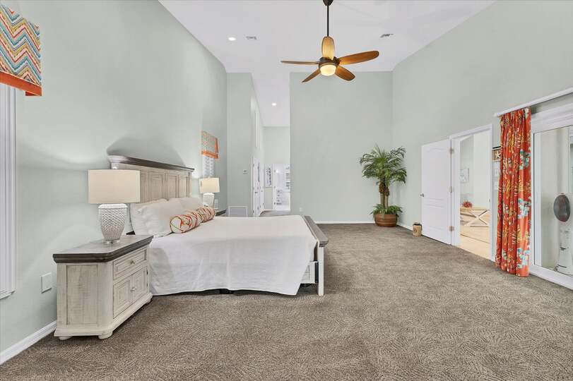 Primary bedroom features a king bed, lanai access, beautiful en suite, and 48-inch Smart TV