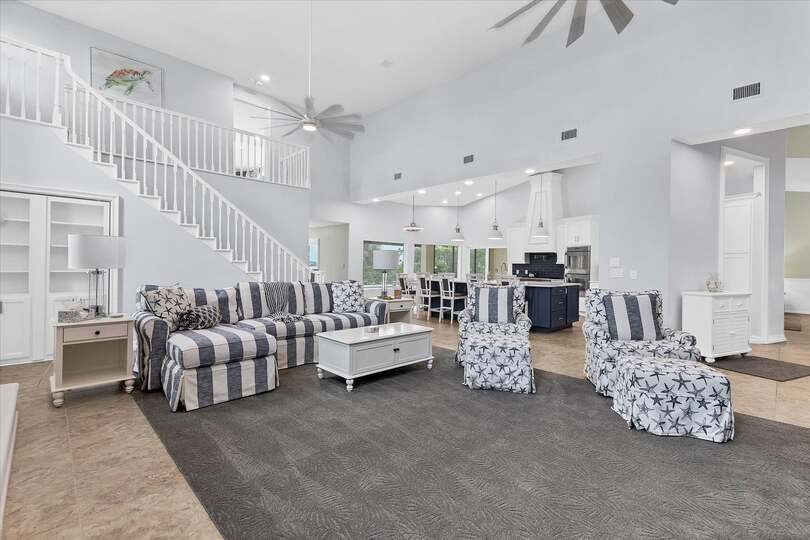 Large, open living space with ample seating, fireplace and 70-inch Smart TV
