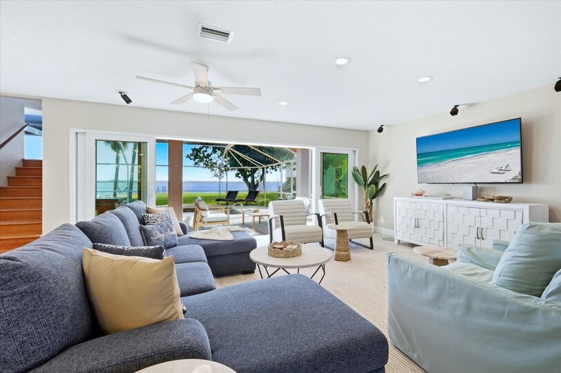 Living room features lots of comfy seating and 70-inch Smart TV