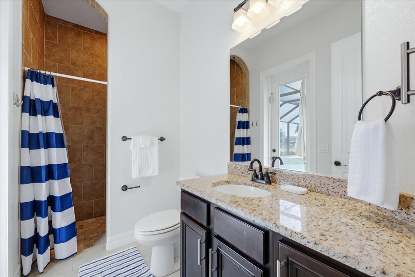 guest bathroom has a walk-in shower and lani