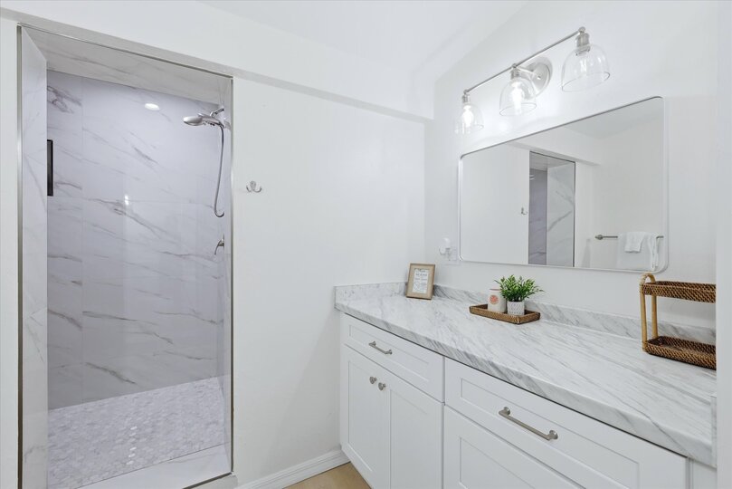 Primary bedroom's attached bathroom with large walk-in shower