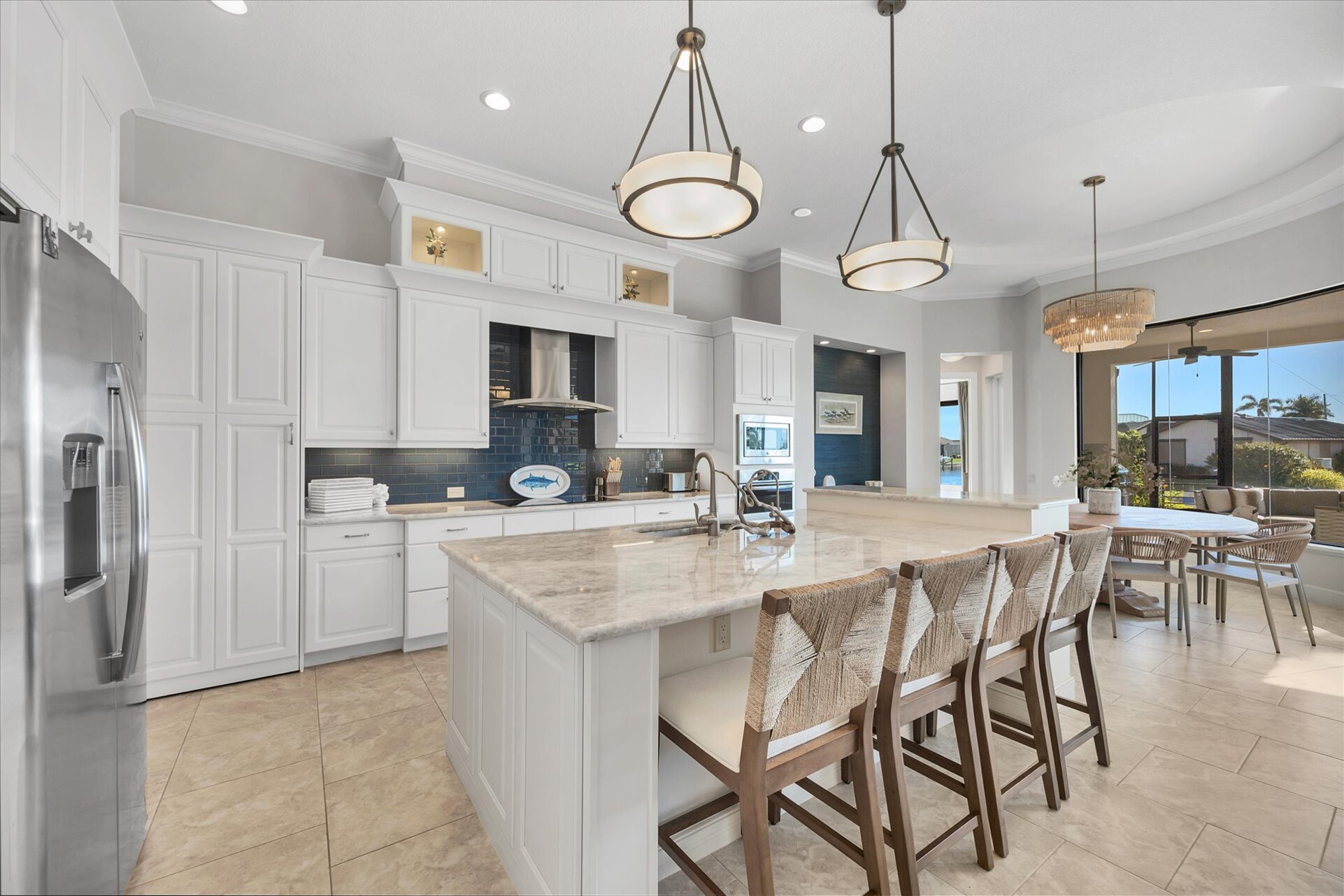 Gorgeous, fully-equipped kitchen over looking the living room and dining areas. Kitchen features lots of countertop & storage space, and stainless-steel appliances. Kitchen island seats 4