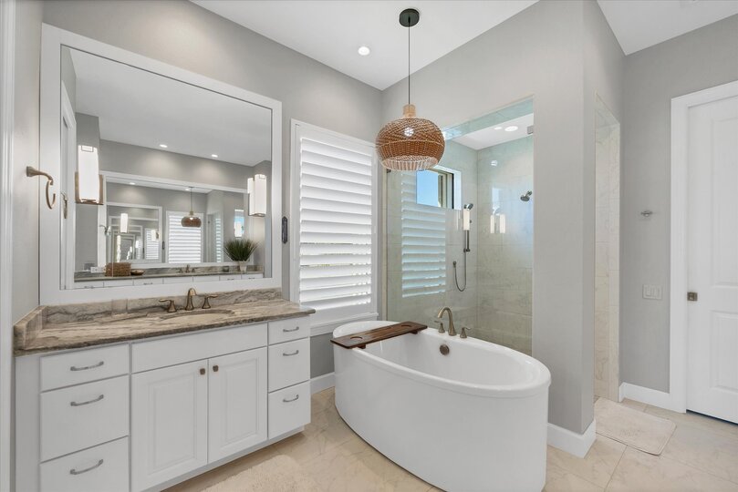 Primary attached bathroom with walk-in shower, soaking tub, and double vanities