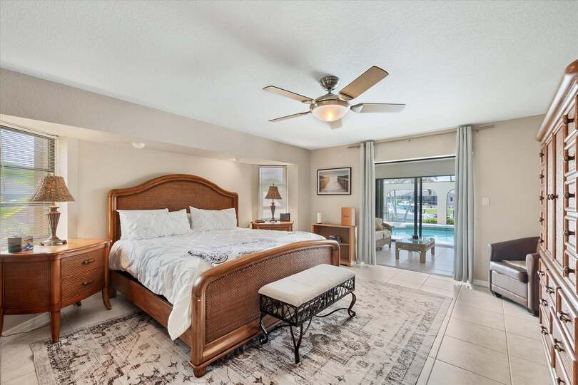 Primary Bedroom with King Bed, Attached Bathroom, Lanai Access, and 43" Smart TV