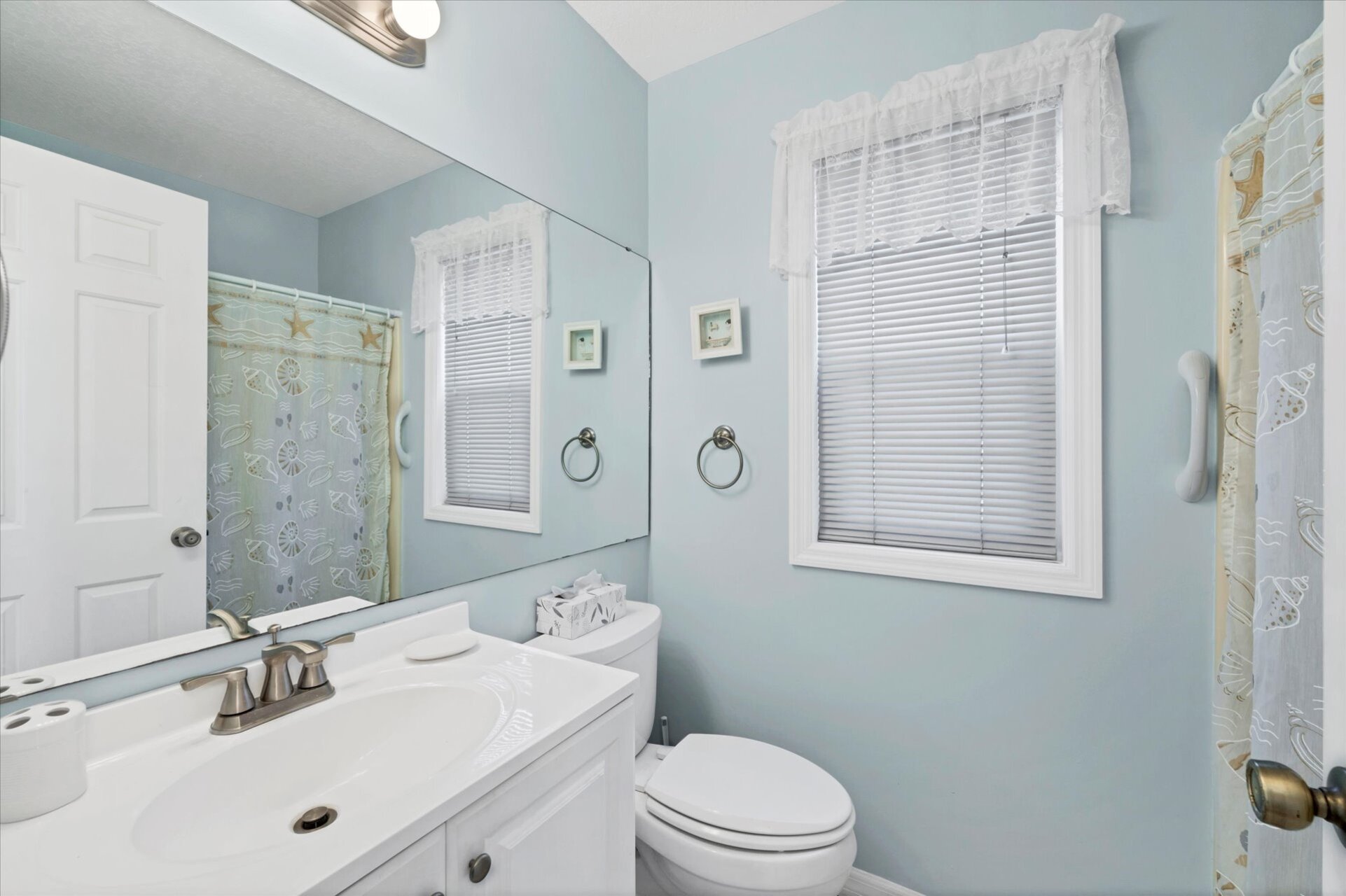 Primary bedroom attached bathroom with vanity area and shower/tub combo