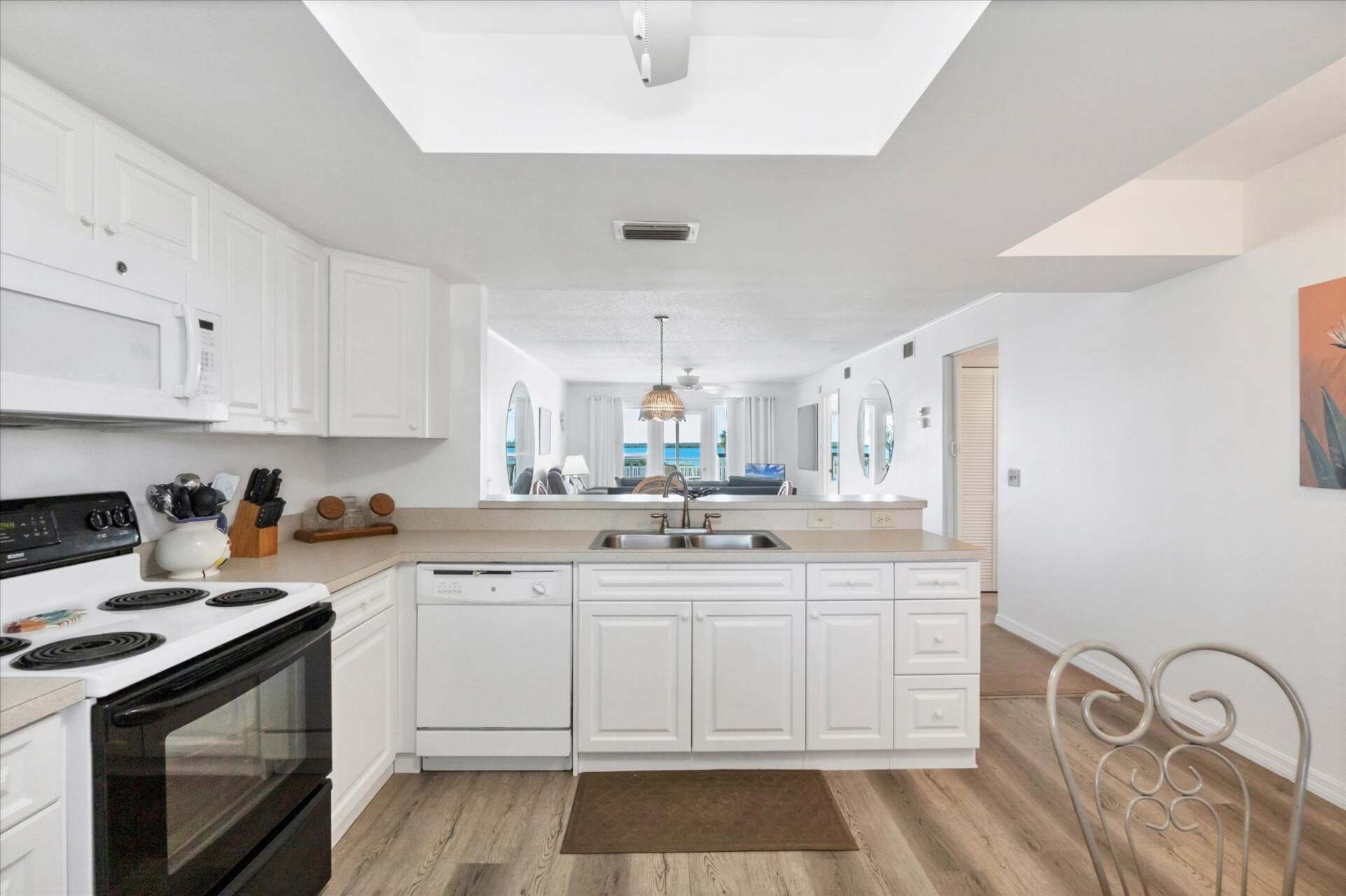 Fully-equipped kitchen overlooking dining and living room areas